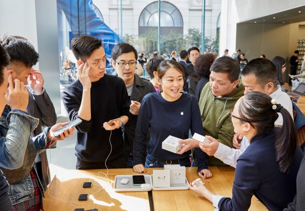 Apple-AirPod-Pro-launch-Shanghai-guests-with-team-member-at-product-table-10302019